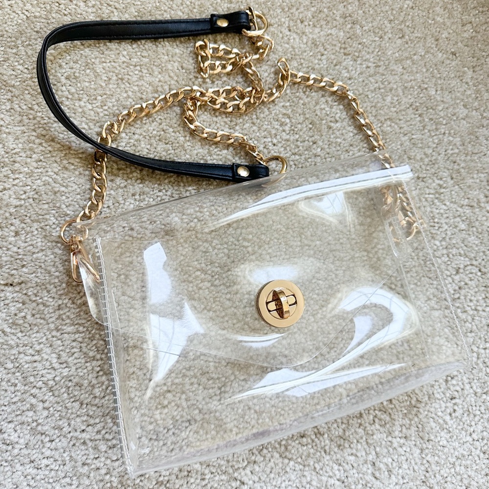 Clear purse with gold ans black hardware